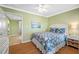 Comfortable bedroom with a queen-size bed, soft lighting, and attached sunroom at 19417 Gulf Blvd # B-210, Indian Shores, FL 33785
