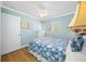 Comfortable bedroom with blue seashell bedding, natural light, and neutral tones at 19417 Gulf Blvd # B-210, Indian Shores, FL 33785