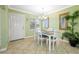 Bright dining room with table, chairs, and chandelier, complemented by an indoor plant at 19417 Gulf Blvd # B-210, Indian Shores, FL 33785