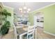Open dining space with garden views and decorative chandelier at 19417 Gulf Blvd # B-210, Indian Shores, FL 33785