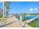 Community dock area with boat lift and walkway along the waterfront at 19417 Gulf Blvd # B-210, Indian Shores, FL 33785