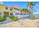 Charming condo building with a white picket fence and walkway leading to the front door and waterfront view at 19417 Gulf Blvd # B-210, Indian Shores, FL 33785