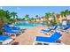 Exterior pool area with many lounge chairs and patio, surrounded by lush landscaping at 19417 Gulf Blvd # B-210, Indian Shores, FL 33785