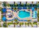 Overhead shot of a stunning pool area with ample seating, palm trees, and a refreshing ambiance at 19417 Gulf Blvd # B-210, Indian Shores, FL 33785