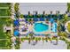 Aerial view of a sparkling pool surrounded by lounge chairs and lush tropical landscaping at 19417 Gulf Blvd # B-210, Indian Shores, FL 33785