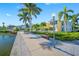 Scenic waterfront homes with pathway, lush landscaping, and inviting curb appeal at 19417 Gulf Blvd # B-210, Indian Shores, FL 33785