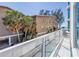 Balcony with glass railings showing views of an adjacent building and blue ocean at 19816 Gulf Boulevard # 201, Indian Shores, FL 33785