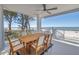 Outdoor living space offering scenic ocean views, dining area, and ceiling fan for comfort at 19816 Gulf Boulevard # 201, Indian Shores, FL 33785