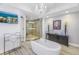 A stylish bathroom with a soaking tub, walk-in shower, and modern fixtures at 19816 Gulf Boulevard # 201, Indian Shores, FL 33785