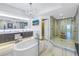 A luxurious bathroom featuring a soaking tub, a spacious glass shower, and double sink vanity at 19816 Gulf Boulevard # 201, Indian Shores, FL 33785