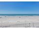Expansive view of a beautiful beach with crystal-clear blue waters at 19816 Gulf Boulevard # 201, Indian Shores, FL 33785