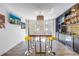 Entertaining space with bar, custom lighting, a large wooden table with chrome stools, and beach views at 19816 Gulf Boulevard # 201, Indian Shores, FL 33785