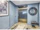 Elevator lobby featuring a stainless steel elevator and blue walls at 19816 Gulf Boulevard # 201, Indian Shores, FL 33785