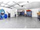Spacious and organized garage with epoxy flooring, storage cabinets, and room for multiple vehicles at 19816 Gulf Boulevard # 201, Indian Shores, FL 33785