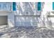 Garage with white doors and a paved driveway providing ample parking space at 19816 Gulf Boulevard # 201, Indian Shores, FL 33785