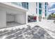 White condo building featuring private parking garages with ample space and modern architecture at 19816 Gulf Boulevard # 201, Indian Shores, FL 33785