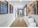 Long hallway featuring hardwood floors, recessed lighting, modern art, and a decorative console table at 19816 Gulf Boulevard # 201, Indian Shores, FL 33785