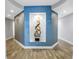 Hallway with unique blue alcove, artistic decor, and modern lighting with wood floors at 19816 Gulf Boulevard # 201, Indian Shores, FL 33785