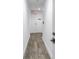 Hallway with wood-style floors leading to a door with an exit sign above it at 19816 Gulf Boulevard # 201, Indian Shores, FL 33785