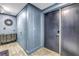 Hallway with an antique dresser, grey wood-look floors and blue colored walls at 19816 Gulf Boulevard # 201, Indian Shores, FL 33785