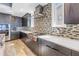 Modern kitchen with stainless steel appliances, cooktop, and dark wood cabinetry at 19816 Gulf Boulevard # 201, Indian Shores, FL 33785