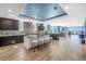 Open concept kitchen featuring an island, modern stools, and stainless steel appliances at 19816 Gulf Boulevard # 201, Indian Shores, FL 33785