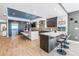 Open concept kitchen with island seating, stainless appliances, and unique backsplash design at 19816 Gulf Boulevard # 201, Indian Shores, FL 33785