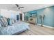 Spacious bedroom with modern decor, TV, balcony access, and a calming atmosphere at 19816 Gulf Boulevard # 201, Indian Shores, FL 33785