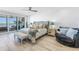 Comfortable bedroom featuring a king bed, ocean view balcony, and stylish decor at 19816 Gulf Boulevard # 201, Indian Shores, FL 33785