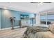 A modern bedroom showcasing beautiful decor, a flat-screen TV, and balcony access at 19816 Gulf Boulevard # 201, Indian Shores, FL 33785