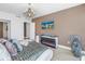Bright main bedroom features a decorative fireplace, chandelier, and wall-mounted television at 19816 Gulf Boulevard # 201, Indian Shores, FL 33785
