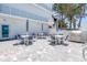 Outdoor patio with tables, chairs, stainless steel grill, spiral stairs, and an ocean view at 19816 Gulf Boulevard # 201, Indian Shores, FL 33785