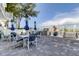 Outdoor patio with pavers, stainless steel grill, tables, chairs, and umbrellas near the beach at 19816 Gulf Boulevard # 201, Indian Shores, FL 33785
