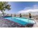 Outdoor pool with brick border surrounded by a white fence under a sunny sky at 19816 Gulf Boulevard # 201, Indian Shores, FL 33785