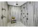 Gorgeous walk-in shower with intricate tile work, dual shower heads, built-in shelving, and bench seating at 19816 Gulf Boulevard # 201, Indian Shores, FL 33785
