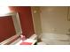 Bathroom featuring white-tiled walls, a framed mirror and a shower-tub combination at 2101 Fox Chase Blvd # 102, Palm Harbor, FL 34683
