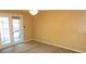 Bedroom with neutral carpet and walls and French doors that let in natural light at 2101 Fox Chase Blvd # 102, Palm Harbor, FL 34683