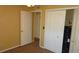 Bedroom featuring carpet, double closets and open doorways creating an inviting space at 2101 Fox Chase Blvd # 102, Palm Harbor, FL 34683
