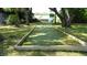 A full-size bocce ball court nestled in the lawn and shady trees at 2101 Fox Chase Blvd # 102, Palm Harbor, FL 34683