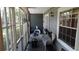 Covered back lanai features screening, tile floor, table and chair seating and a fan at 2101 Fox Chase Blvd # 102, Palm Harbor, FL 34683