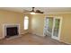 Beige living room featuring a fireplace, ceiling fan, and large windows for ample light at 2101 Fox Chase Blvd # 102, Palm Harbor, FL 34683
