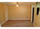 A simple, bright living room with beige carpet and walls, and standard lighting at 2101 Fox Chase Blvd # 102, Palm Harbor, FL 34683