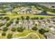 Aerial view of the golf course community, featuring homes near lakes and greenery at 2112 Acadia Greens Dr # 62, Sun City Center, FL 33573