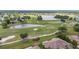 Stunning aerial view of a golf course community with lush landscaping and serene lakes at 2112 Acadia Greens Dr # 62, Sun City Center, FL 33573