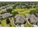Aerial view of the house showcasing the landscaped yard, and neighborhood at 2112 Acadia Greens Dr # 62, Sun City Center, FL 33573