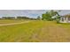 Expansive backyard with lush grass and landscaping, showcasing the tranquil community and well-maintained grounds at 2112 Acadia Greens Dr # 62, Sun City Center, FL 33573