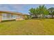 View of the backyard and community, the covered lanai offers a beautiful view of the surrounding greenery at 2112 Acadia Greens Dr # 62, Sun City Center, FL 33573