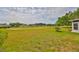 Spacious backyard with lush green lawn and views of the golf course at 2112 Acadia Greens Dr # 62, Sun City Center, FL 33573
