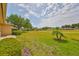 Lush backyard with a spacious lawn and views of the green at 2112 Acadia Greens Dr # 62, Sun City Center, FL 33573