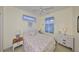 Cozy bedroom with floral bedding, blue curtains, and light yellow walls, creating a cheerful and inviting atmosphere at 2112 Acadia Greens Dr # 62, Sun City Center, FL 33573